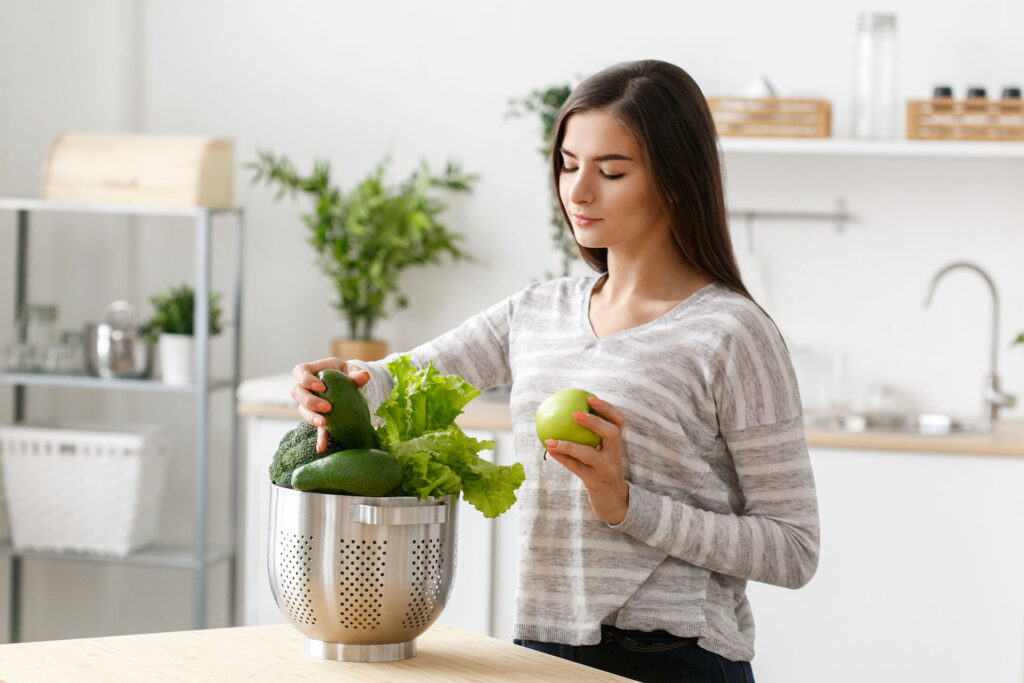 woman on kitchen home with green vegetables cookin 2021 04 04 03 31 47 utc1